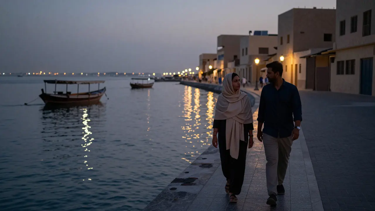 Silhouettes of a man and woman walking together along Dubai Creek at twilight, lanterns reflecting on water.